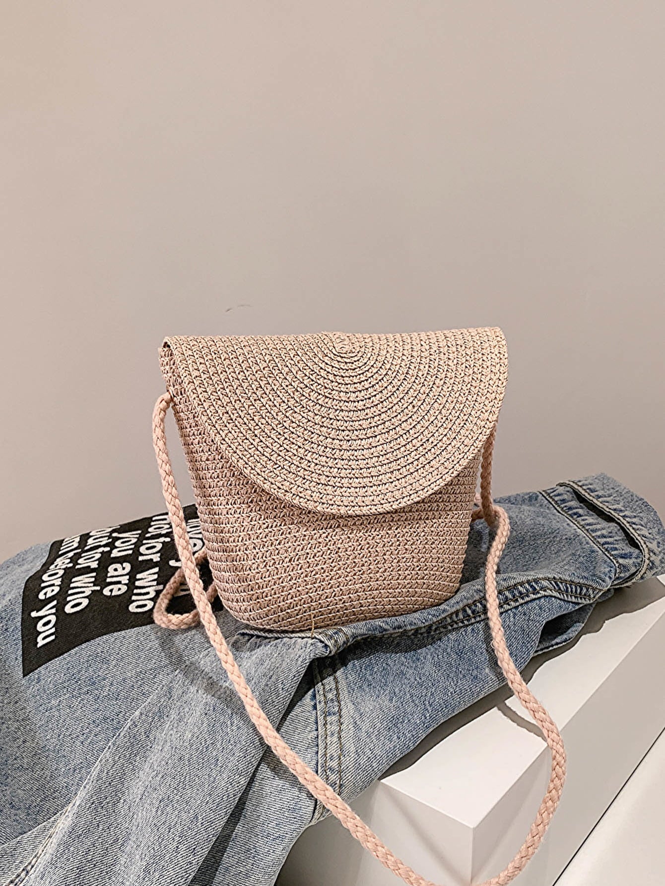 crochet shoulder handbag, light apricot, front view, atop a denim jacket
