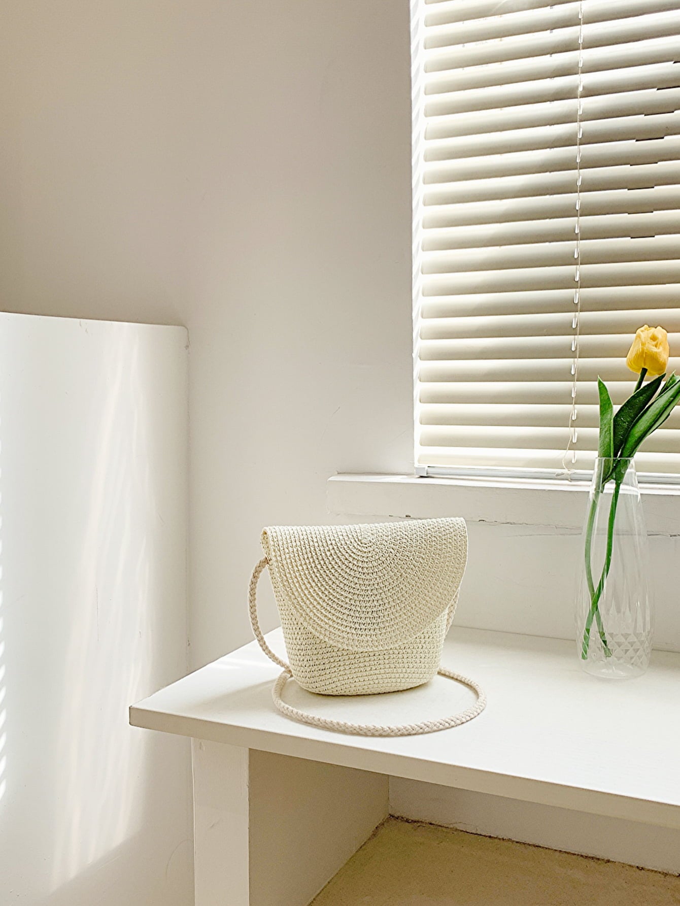 crochet shoulder handbag, white, angled view, on white countertop