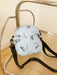 butterfly print polyester shoulder handbag, gray with gray butterflies, on glass and metal slatted cart