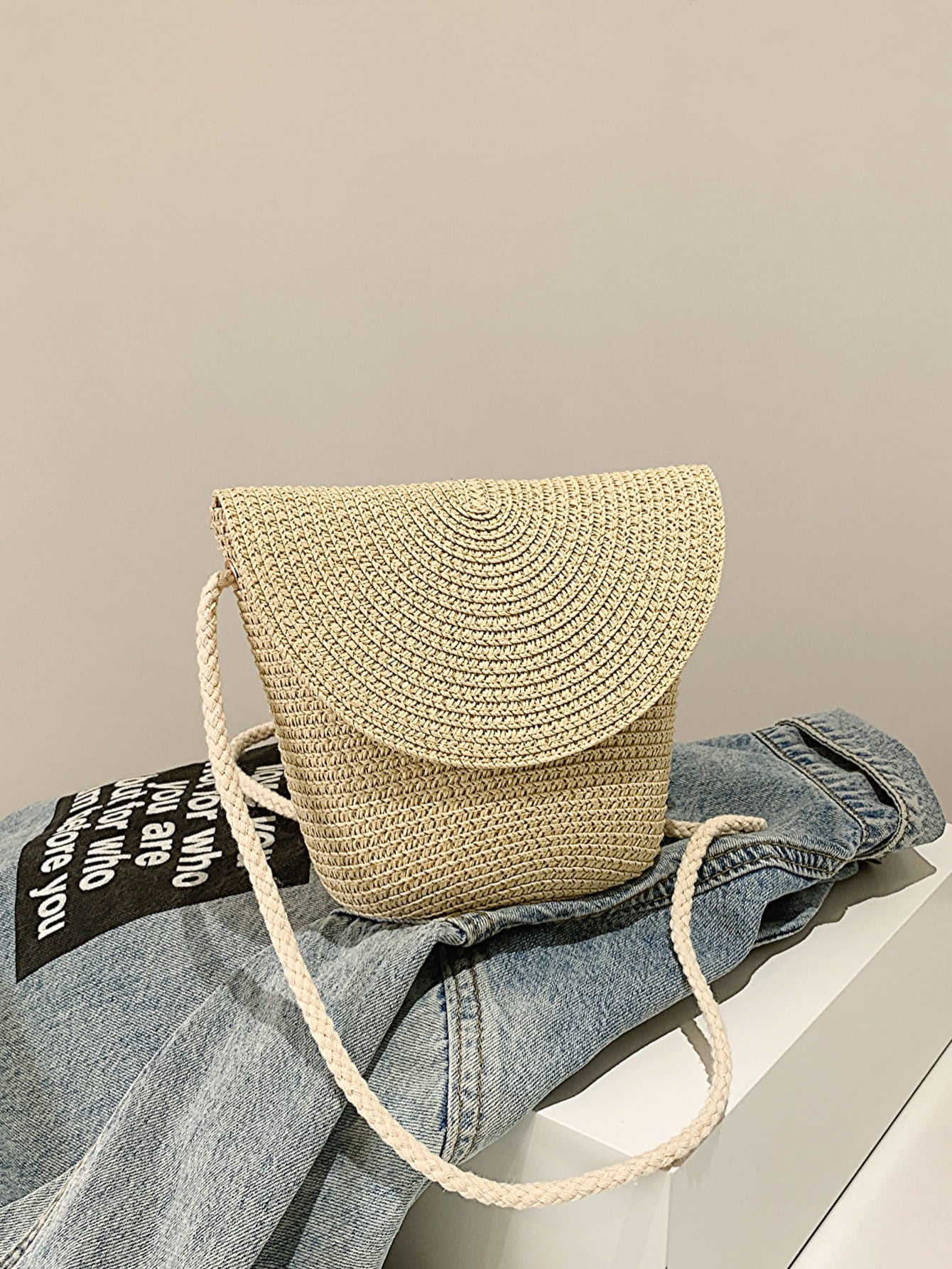 crochet shoulder handbag, tan, atop a denim jacket