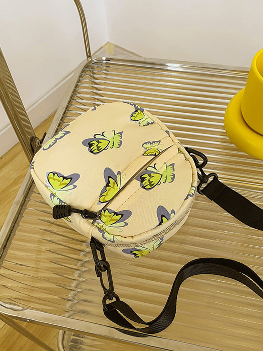 butterfly print polyester shoulder handbag, yellow with green butterflies, flat view, atop glass and metal slatted cart