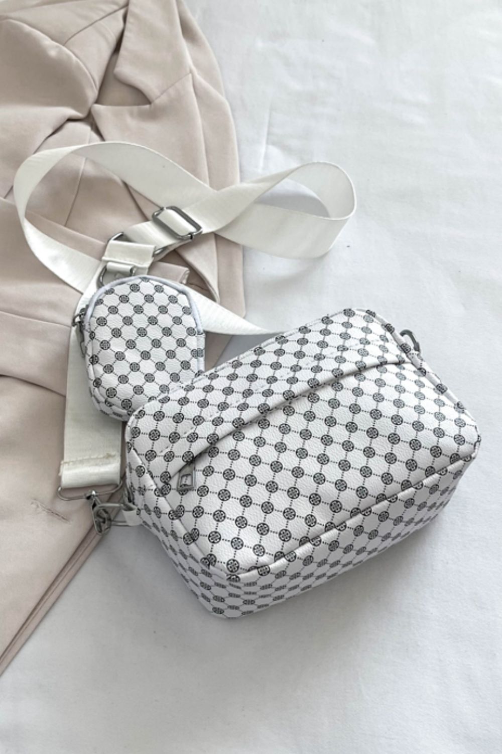 geometric pu leather shoulder handbag with small purse, white, rear view, on bed