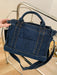 denim shoulder handbag, dark blue, held by a woman