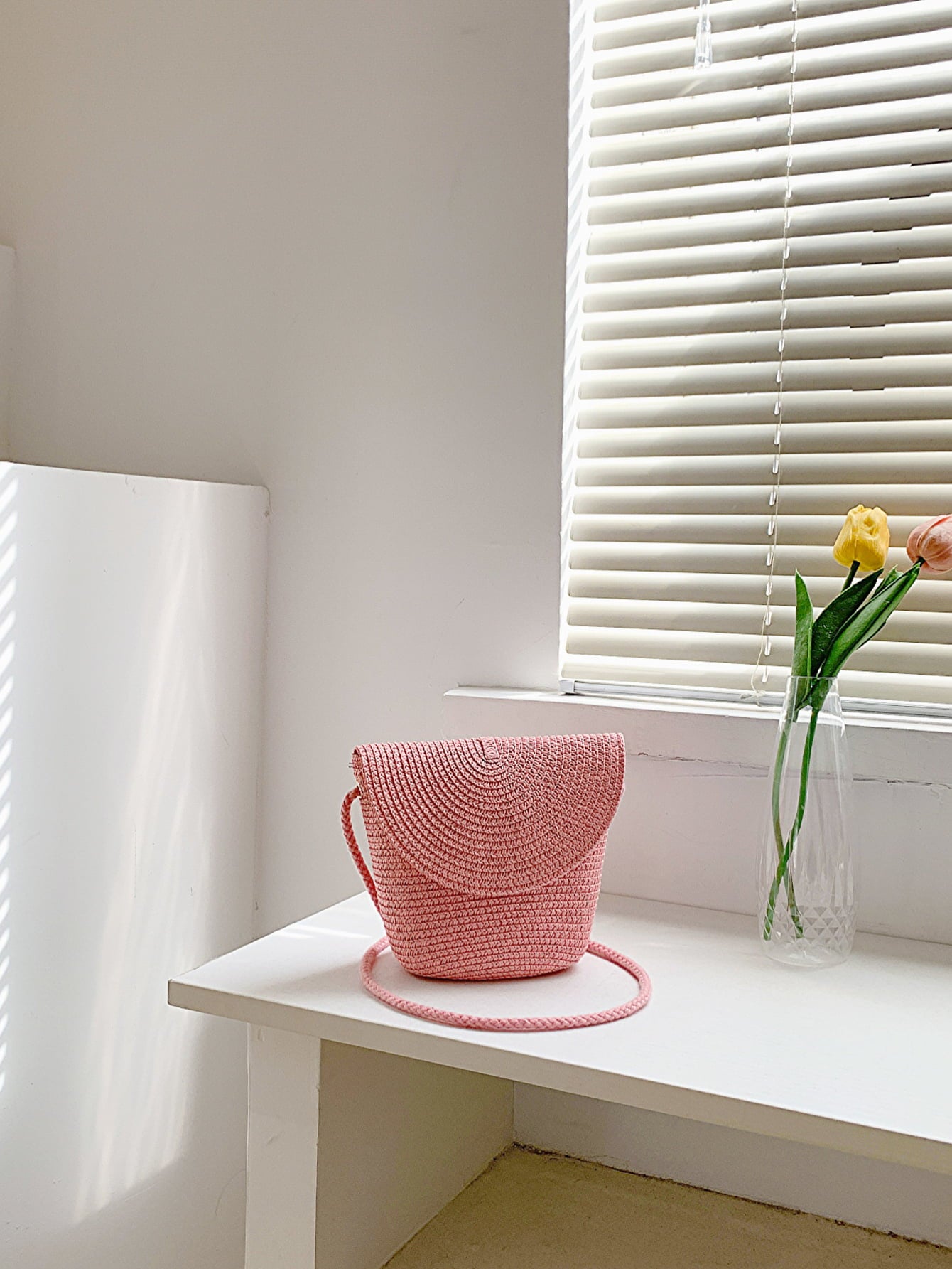 crochet shoulder handbag, blush pink, front view, on white countertop
