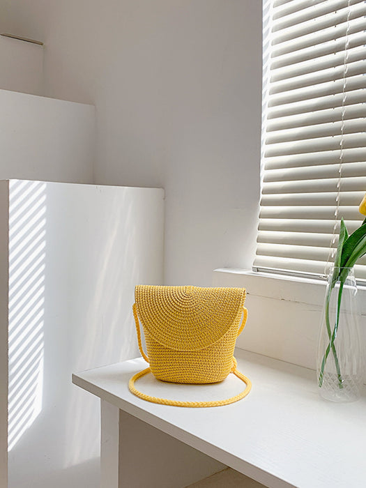 crochet shoulder handbag, mustard, angled view on white countertop
