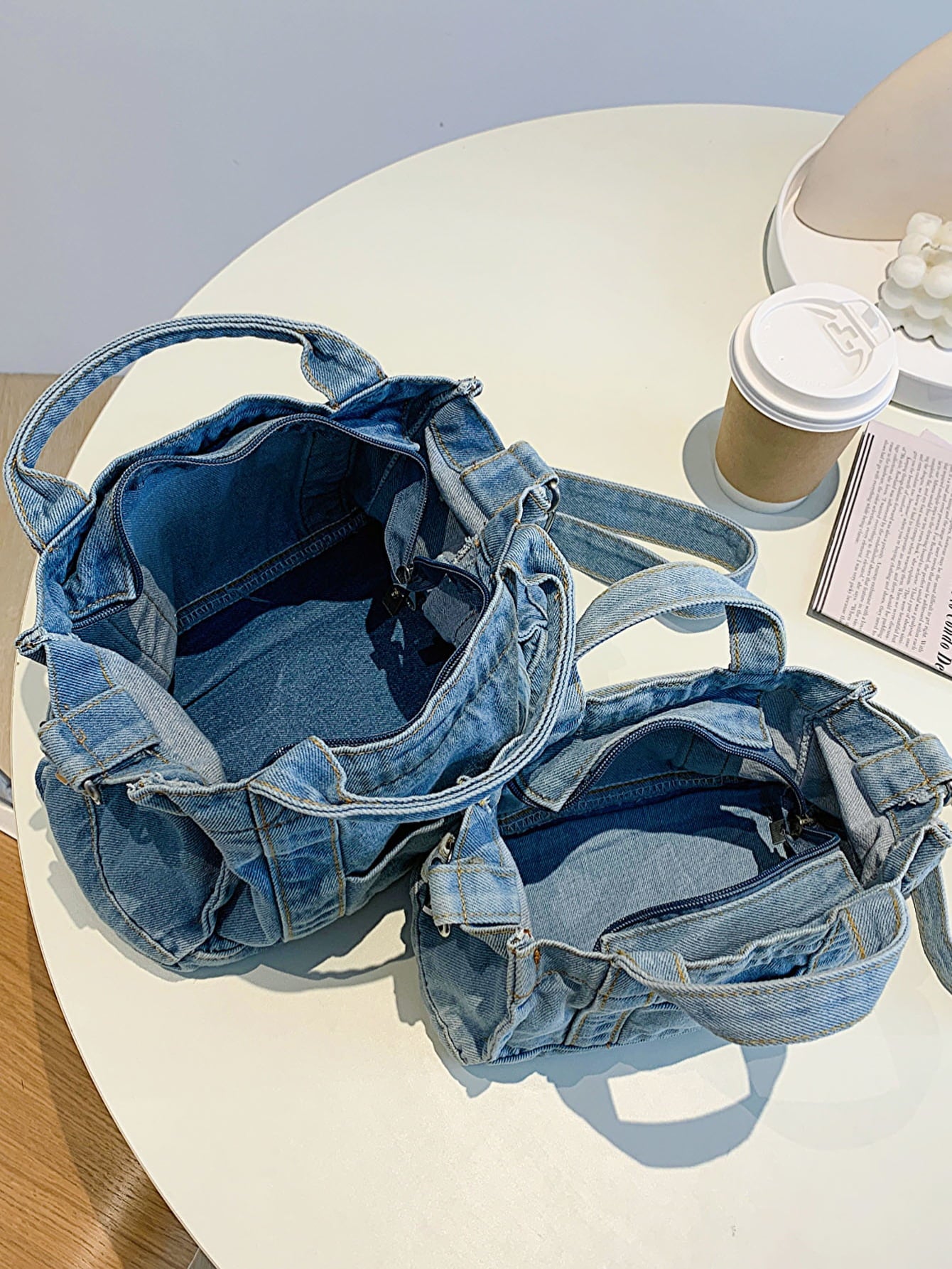 denim shoulder handbag, dark blue, top-down interior shot, on top of side table