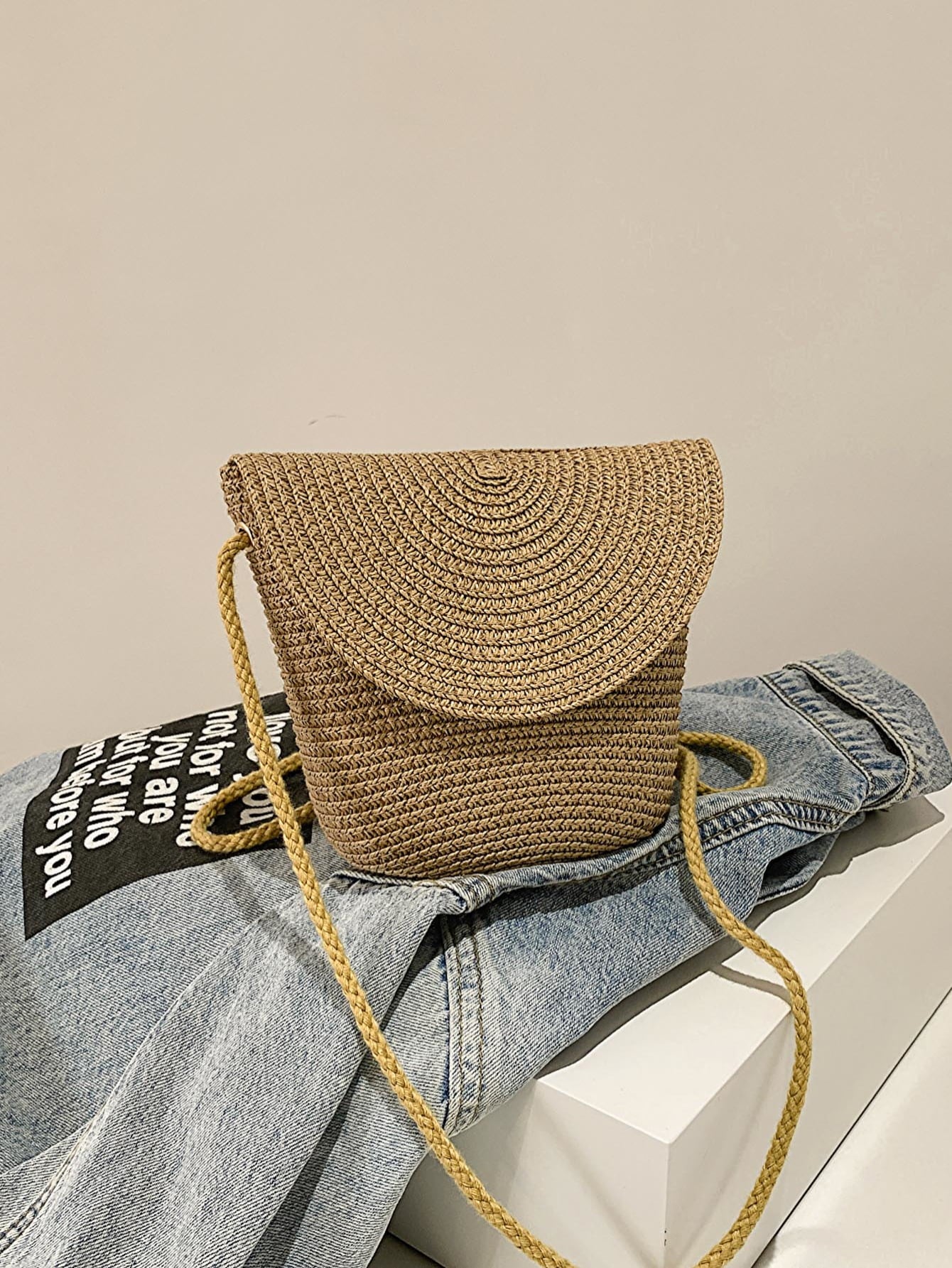 crochet shoulder handbag, camel, front view, atop a denim jacket