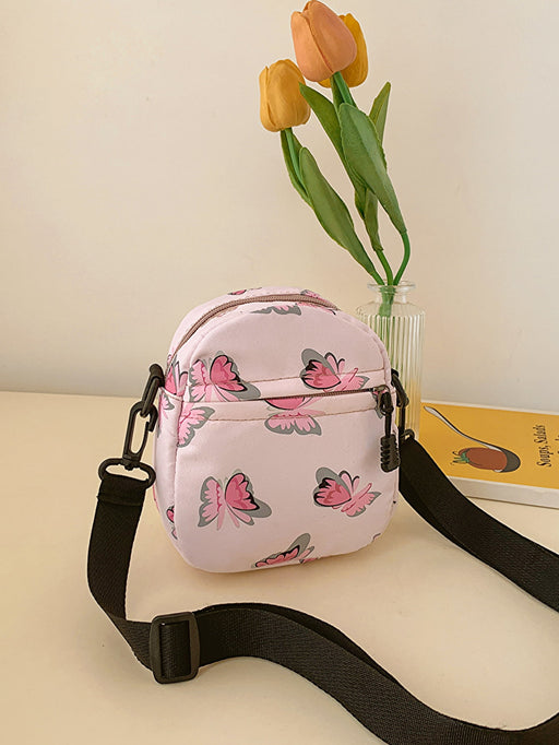 butterfly print polyester shoulder handbag, pink with pink butterflies, yellow tulips on counter