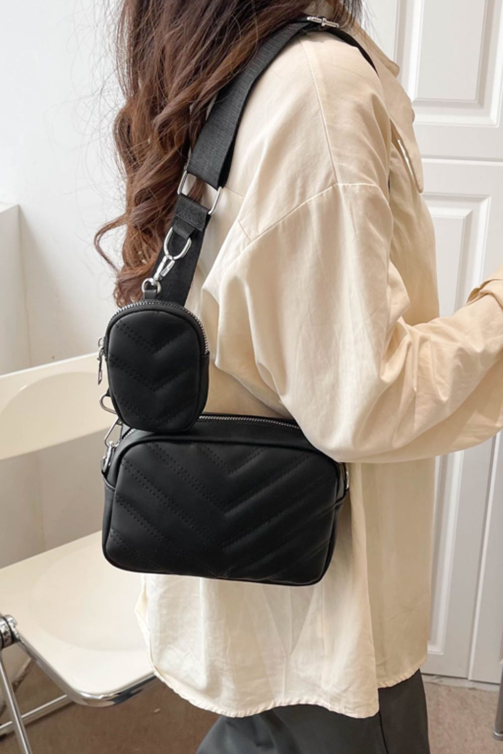 pu leather shoulder bag with small purse, black, worn on a woman's shoulder