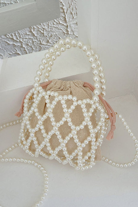 pearl polyester crossbody handbag, white pearls, propped on a white counter corner