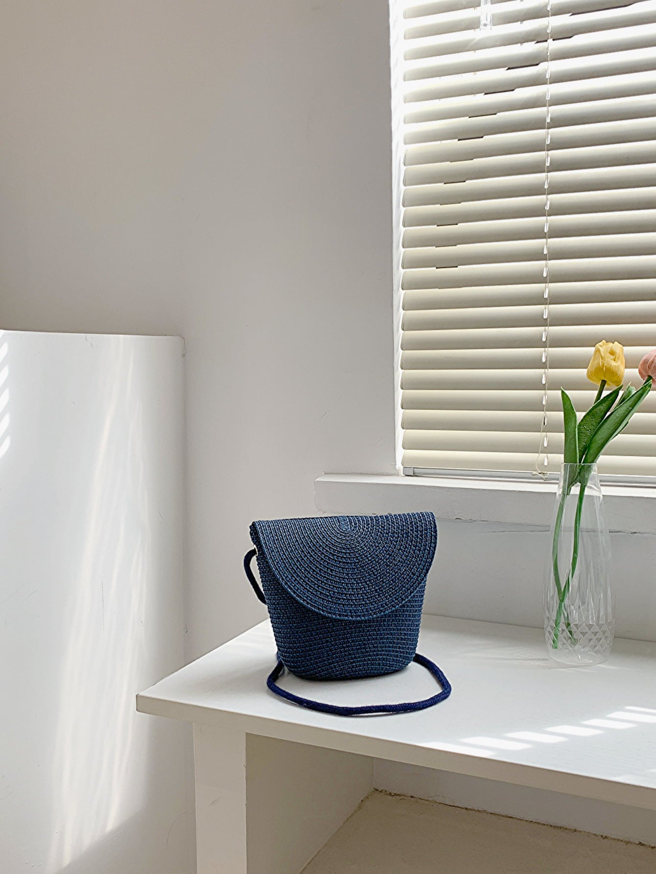 crochet shoulder handbag, peacock blue, on countertop near window with white blinds, tulips in a vase
